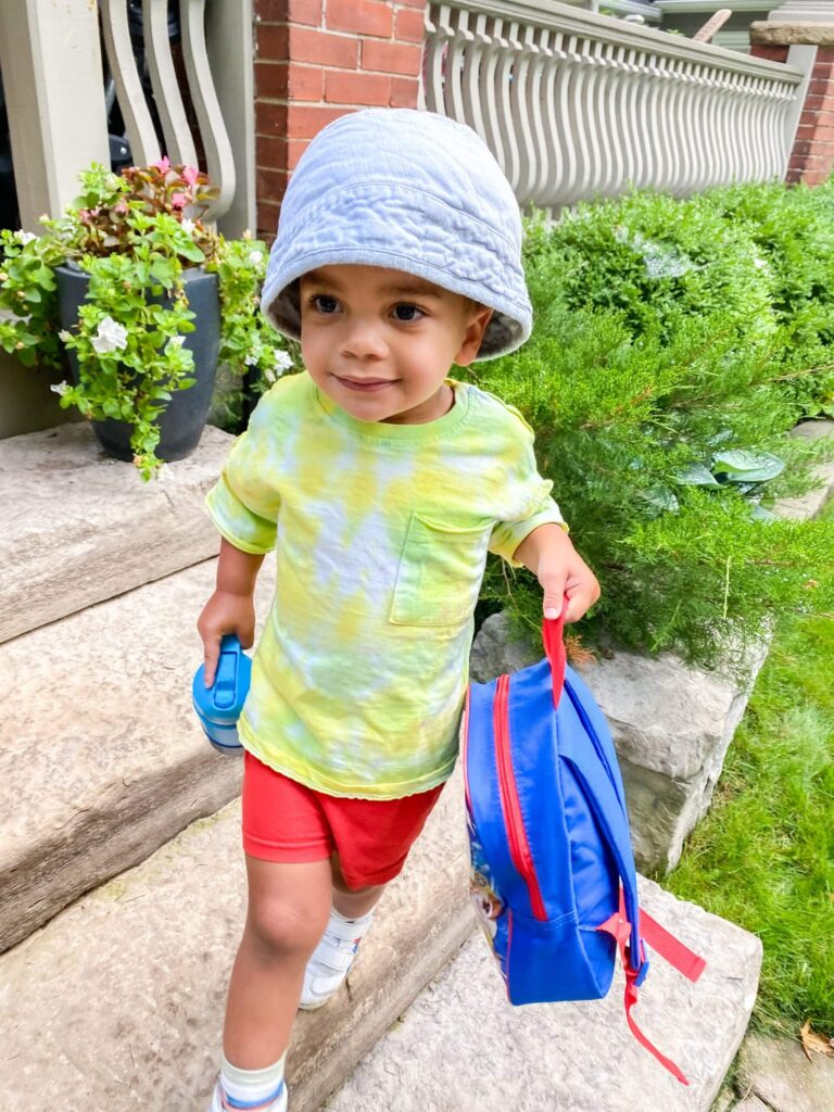A young child wearing a bucket hat