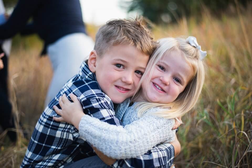 Boy and girl siblings hugging