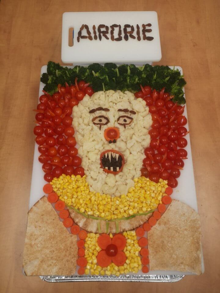 Clown made out of pita, tomatoes, broccoli, corn