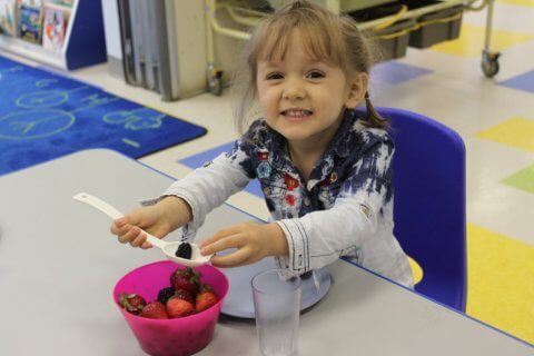 eating berries at Bloor Christie childcare centre