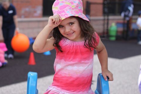 child holding hat