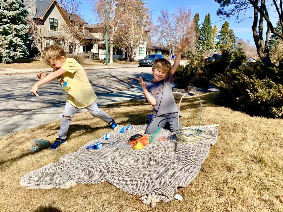 Two children having a picnic outside