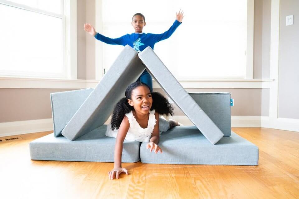 My puffin play couch - two children playing on a play couch