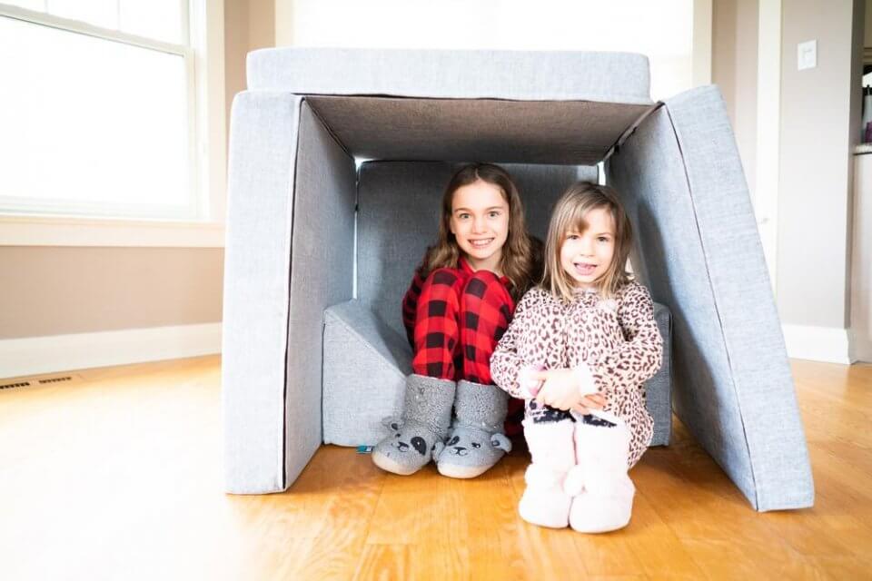 My puffin play couch - two children playing under a play couch