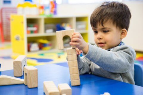 Child playing with building blocks