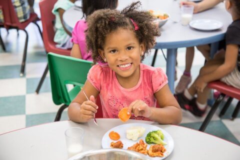 Child eating Kidco Kitchen healthy lunch