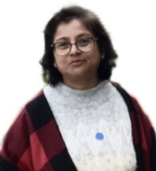 A person with short dark hair, glasses, and a neutral expression is wearing a gray sweater and a red checkered jacket, standing against a plain white background.