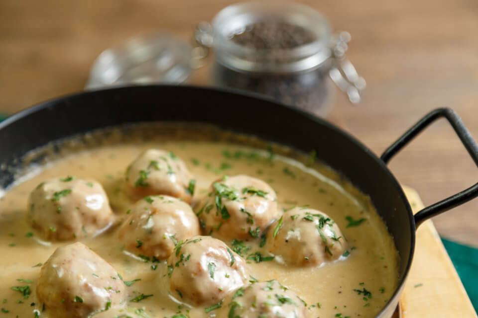 Swedish meatballs in a black pan.