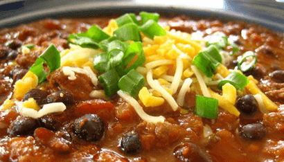 Chili with beans, cheese, and onions