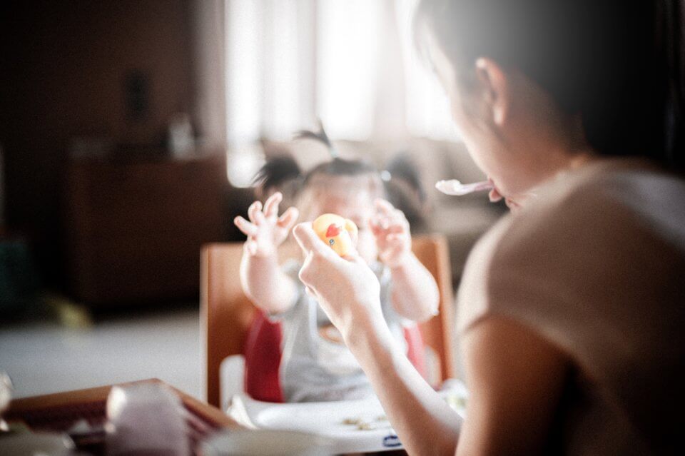 Baby girl being fed by her mother.