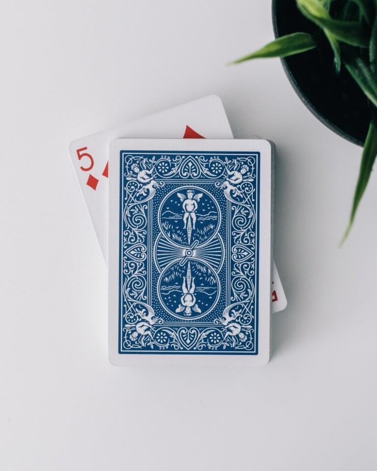 A blue deck of cards showing the 5 of diamonds