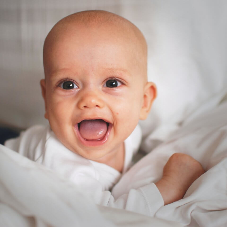 Baby on white background with mouth open