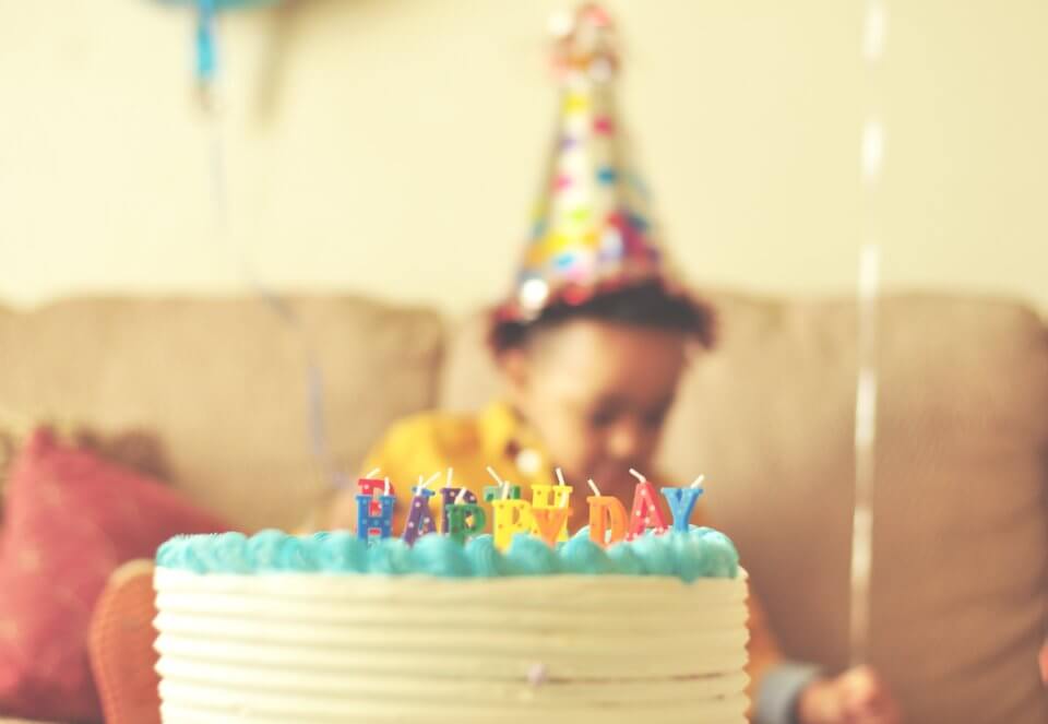 Child birthday party with cake and candles.