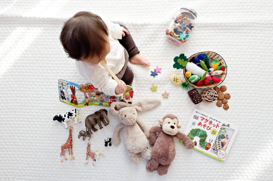 Birds eye image of a child playing with toys.