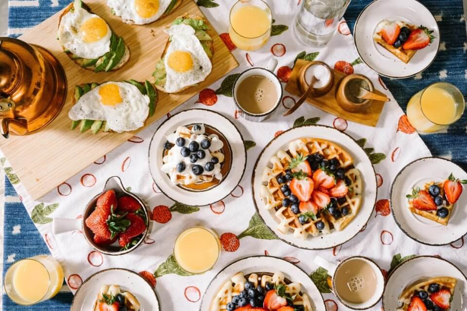 Brunch on table with waffles and eggs