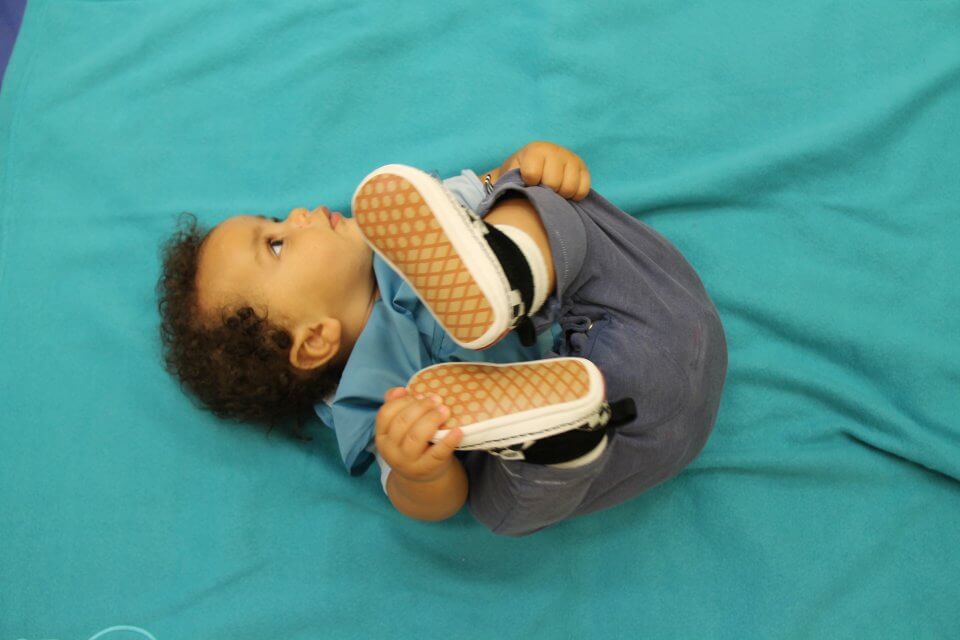 child holding his feet