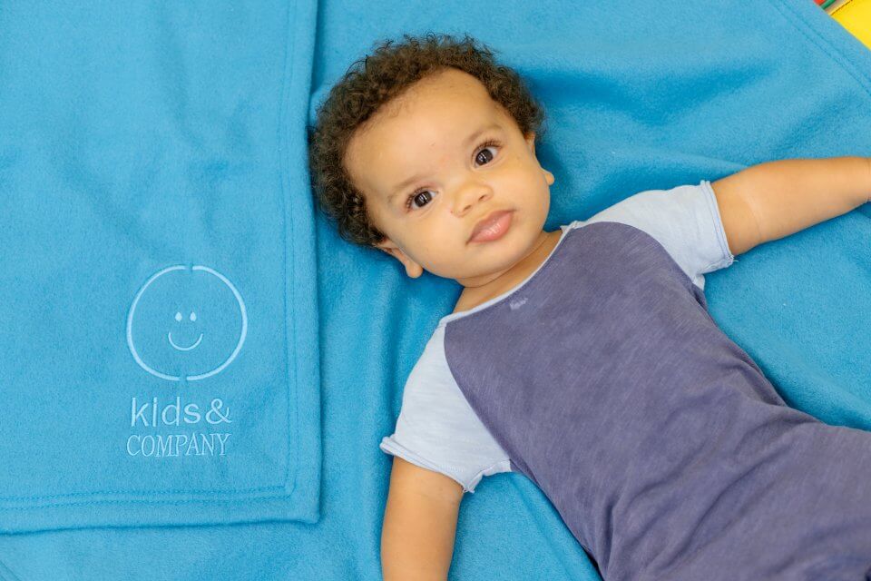 Baby boy on a blue blanket, blue shirt