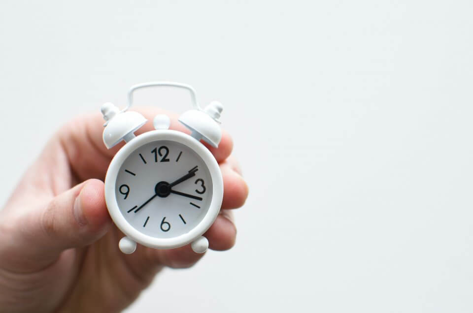 mini white clock on a white background