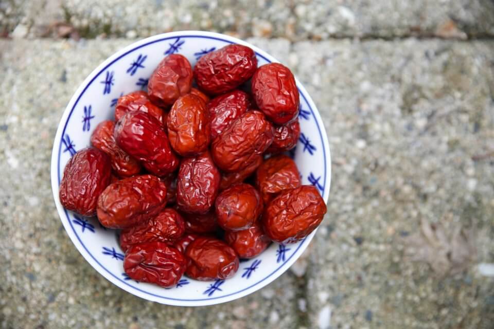 Dates on a blue and white plate on a grey background