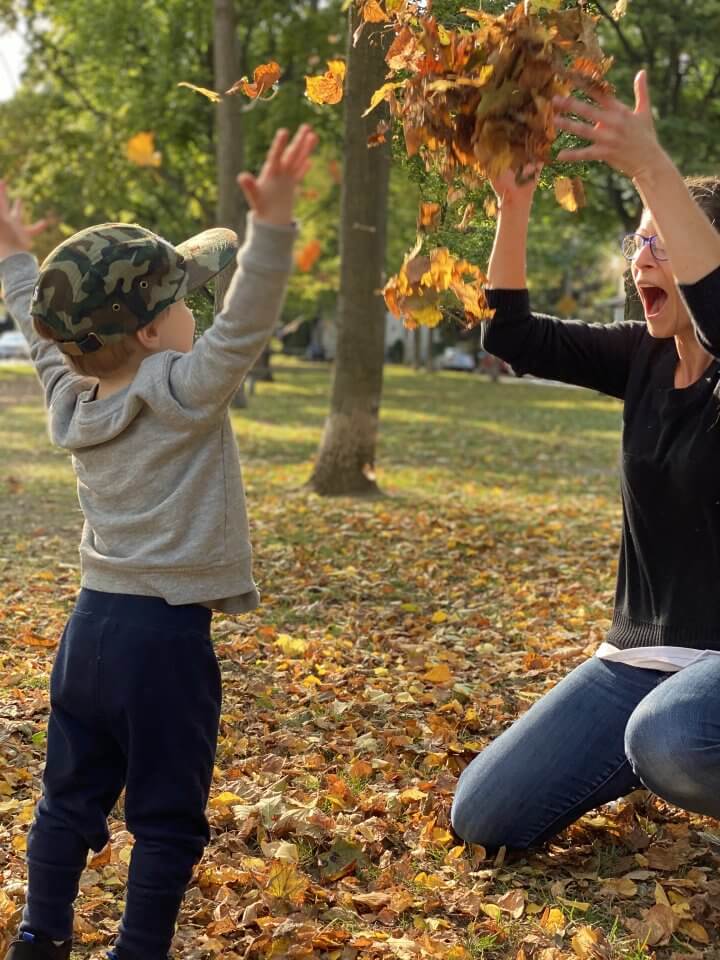 Mom and son throwing leaves