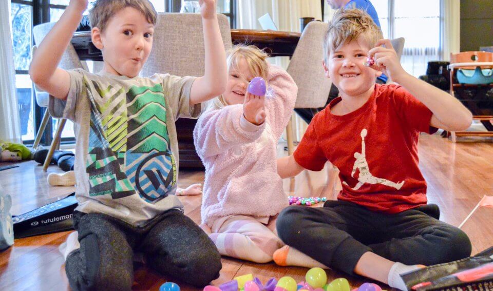 Three children celebrating easter in quarantine