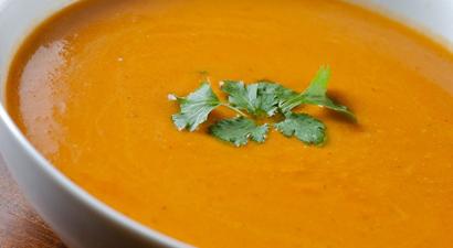 Butternut Squash soup in a white bowl with cilantro on top