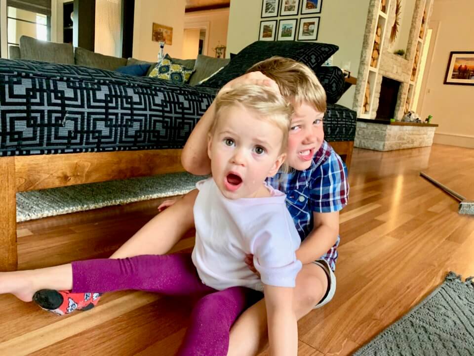 Brother and sister playing together on the floor