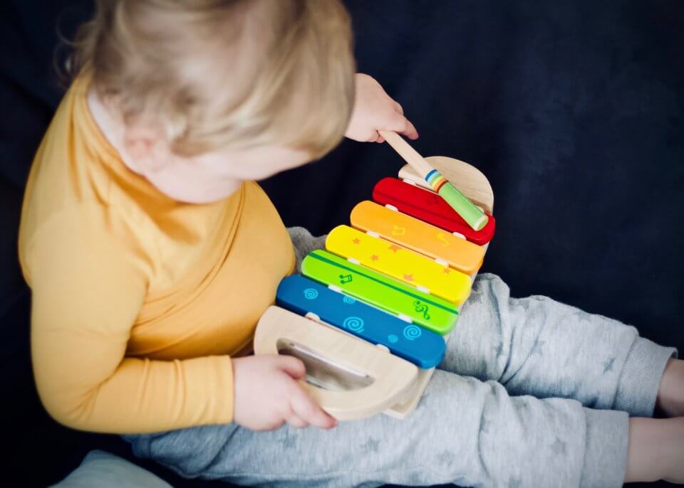 Child playing with a music toy.