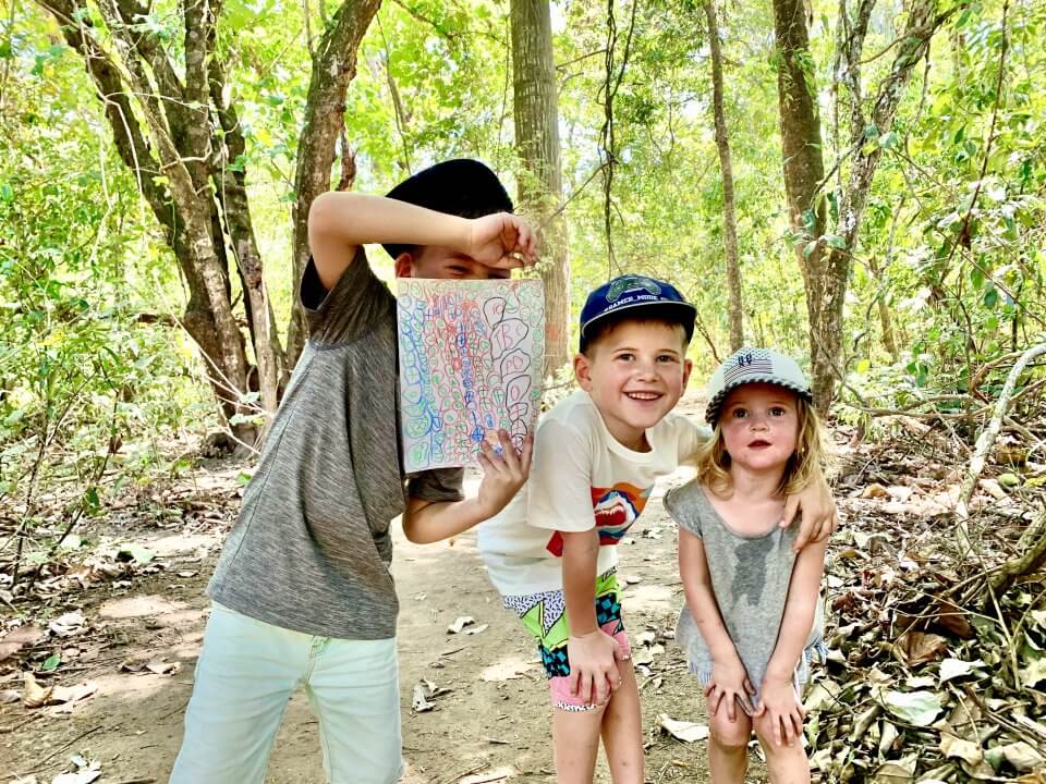 Three children in the forest.