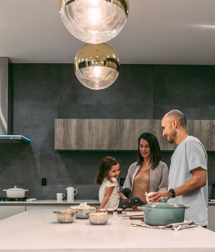 Family of three in the kitchen cooking