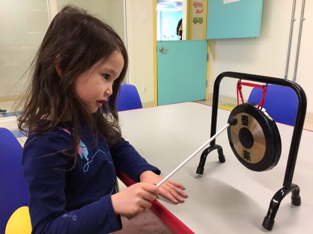 Young girl using a musical instrument