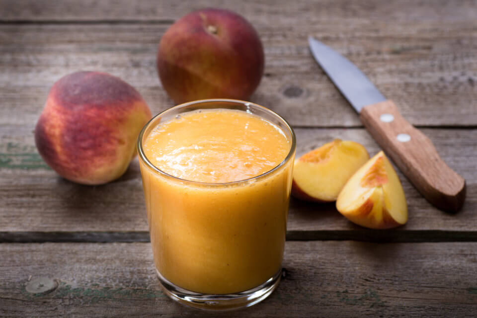 Peach smoothie on a wooden table