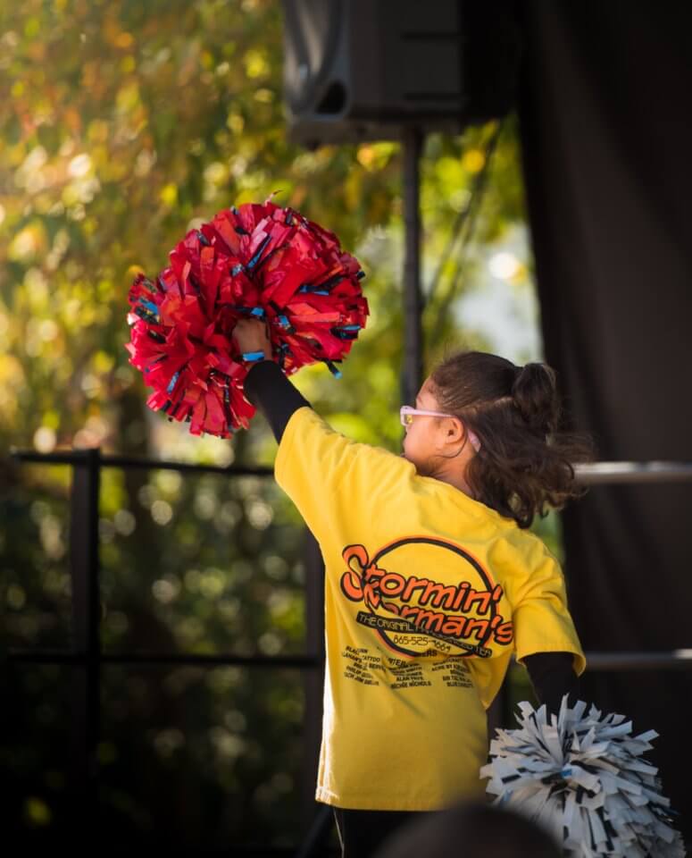 Young girl with pom poms