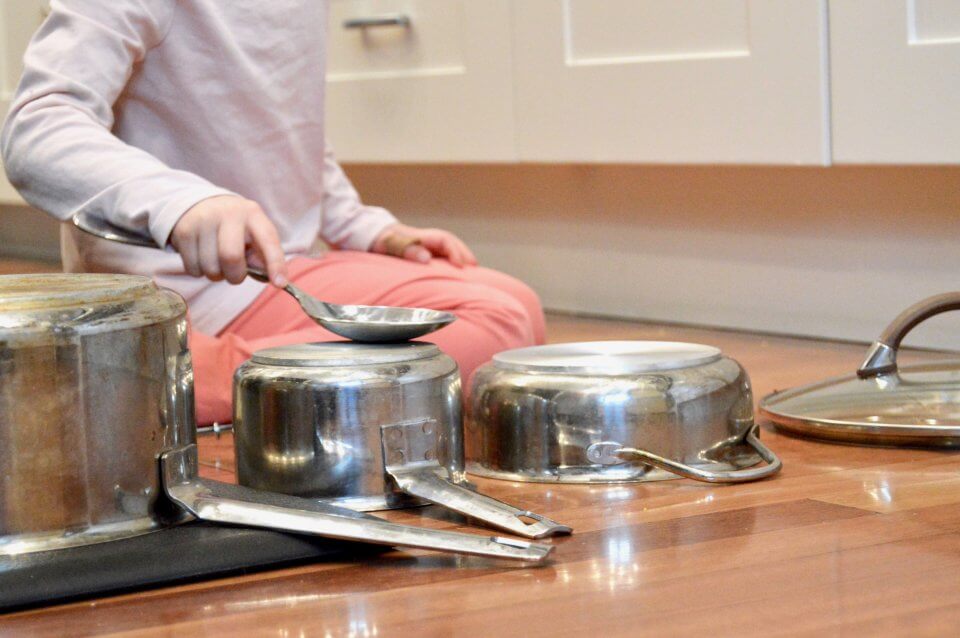 Child playing with pots and pans.