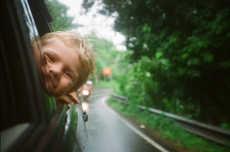 Happy child on road trip with family