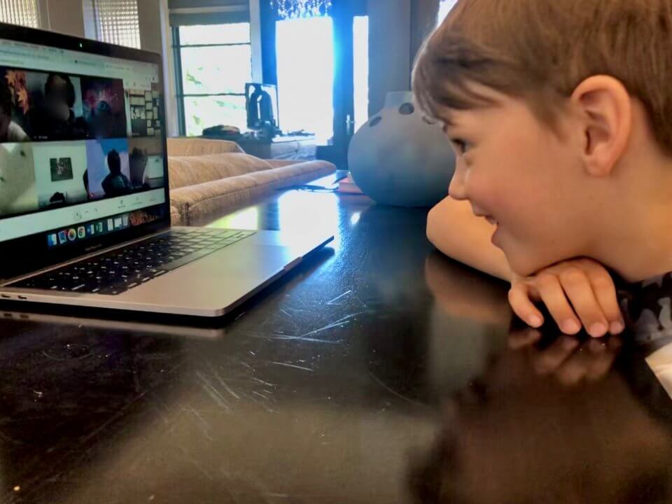 Child doing a video call with family members while at home